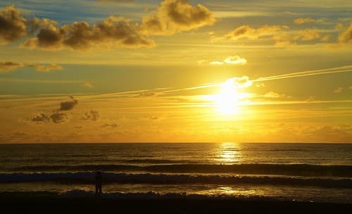 My friend Francoise taking a picture of the setting sun, Lacanau-Ocean, Aqutaine, France