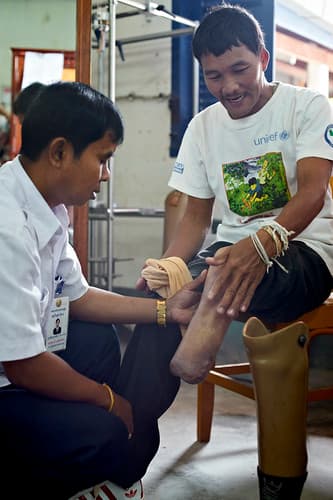 survivor has his prosthetic checked at COPE centre, Vientiane, Laos