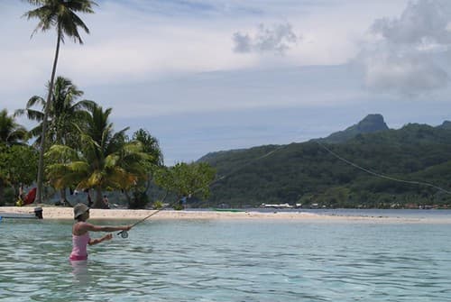 Patricia casting in the lagoon, Raiatea