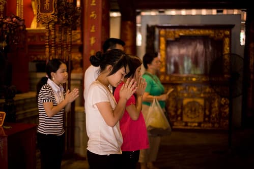 Girls Praying in Front of Altar