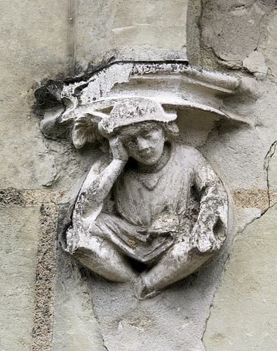 A sad or pensive boy: A 15th C. doorframe corbel, Montreuil-Bellay, France