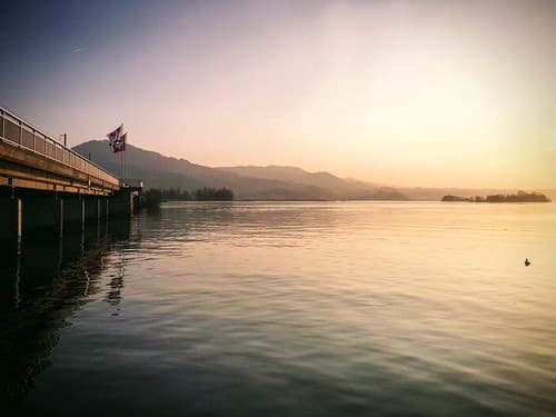 Sunset over the Zürichsee lake with Seedamm causeway in Rapperswil, St. Gallen, Switzerland, March 2019