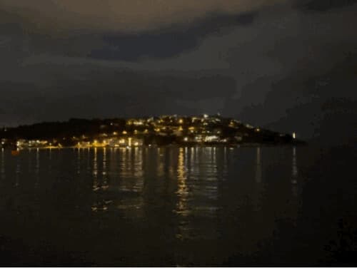 A nighttime scene of a town on a coast of the sea near Nice, Provence-Alpes-Côte d'Azur, France, February 2023