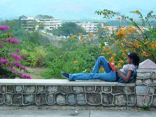 Young Woman Reads Overlooking Santiago de Cuba - Cuba