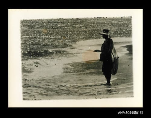 Photograph by Oskar Speck depicting a man fishing