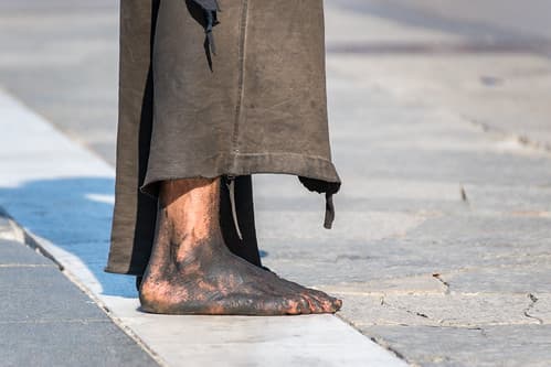 Barefoot in the city of Milan, Italy