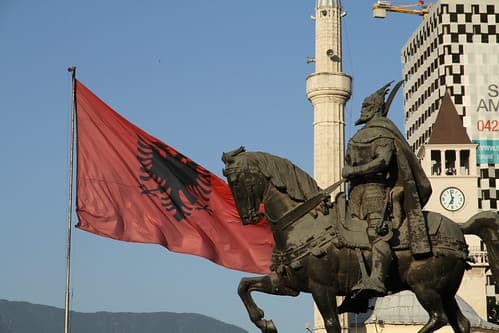 Skanderberg on the horse - Albanian national flag - American hospital in the back